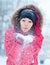 Happy young woman plays with a snow