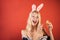 Happy young woman in a rabbit costume with Easter eggs. Surprise woman. Happy easter. Fashion portrait of beautiful