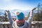 Happy young woman is raising her hands on the mountain, enjoying the view over Salzburg. Winter time on Gaisberg, Salzburg,