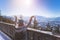 Happy young woman is raising her hands on the mountain, enjoying the view over Salzburg. Winter time on Gaisberg, Salzburg,