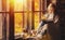 Happy young woman reading book by window in fall