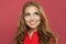 Happy young woman with red curly hair rejoicing at positive news and looking up with joyful and charming smile. Ginger student