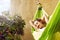 Happy young woman relaxed lies in a hammock on the balcony House