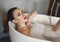 Happy young woman relaxing in bathtub