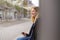 Happy young woman relaxing waiting for a bus