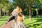 Happy young woman riding bike on road in park, beautiful hipter teenager having fun and laughing