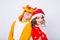 Happy young woman in santa claus hat and man in carnival costume of deer. Fun, holiday, joke and christmas concept