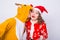 Happy young woman in santa claus hat and man in carnival costume of deer. Fun, holiday, joke and christmas concept