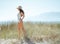 Happy young woman on seashore looking into distance