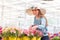 Happy young woman selecting a petunia plant