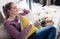 Happy young woman sitting with European breakfast for relaxing morning