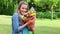 Happy young woman smelling flowers