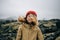 Happy young woman smiles to camera in wind