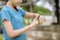 Happy young woman in sportswear using smart watch while exercising in park