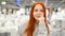 Happy young woman is standing in a shopping mall