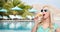 Happy young woman in sunglasses eating ice cream