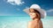 Happy young woman in sunhat over summer beach