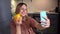 Happy young woman take photo with yellow bell pepper in modern kitchen.