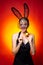 Happy young woman wearing bunny ears and having Easter Eggs. Bunny rabbit ears costume.