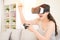 Happy young woman winning vr game