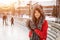 Happy young woman in a wolf hat in winter at the ice rink