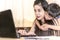 Happy young woman working and learning online from laptop. Mother and kid smile work from home concept