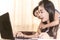 Happy young woman working and learning online from laptop. Mother and kid smile work from home concept