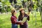 Happy young women gardener holding of ripe grape