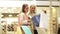 Happy young women with shopping bags in mall