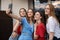 Happy young women standing together on terrace, smiling and taking selfie on smartphone closeup. Having fun and enjoying