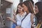 Happy young women using cash machine. Women using credit card.