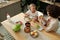 Happy youthful girl and her mother eating fresh vegetable sandwiches