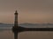 Harbor basin with famous historic Lindau lighthouse on the coast of Lake Constance, Germany.