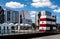 Harbor bath with entrance portal in red and white, in the background there are residential and office buildings.