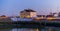 The harbor of blankenberge lighted at night, white building and houses, popular city architeture