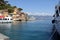 Harbor with boats, luxury yacht UTOPIA in the background at the mouth of the harbor, Portofino, Liguria, Italy