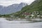 Harbor and houses of little village in northern fjord at Oksfjord, Norway