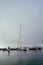 Harbor moored boats sailboat high fog morning