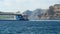 Harbor Ormos Athinios at Santorini Isle Greece. Catamaran ferry leaving in the harbor.