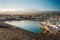 The harbor of Riposto during the sunset; snowy volcano Etna in the background