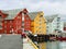 Harbor and seafront in Tromso. Multicolored houses and ships in overcast summer