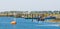 The harbor of tholen with docked ships and a boat sailing, Bergse diepsluis, Oosterschelde, zeeland, The netherlands, 22 april,