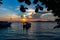 Harbor with two boats  in front of amazing colorful sunset  in Bunaken National Park