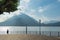 Harbor of Varenna at Lake Como with Fisherman in backlight