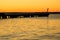 Harbour Beacon And Breakwater At Sunrise With Windmills In Background