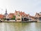 Harbour with boats and quayside with houses in old town of Makkum, Friesland, Netherlands