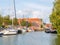 Harbour with boats and quayside with houses in old town of Makkum, Friesland, Netherlands