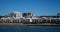 Harbourside condominium apartment housing with grass frontage against blue water and sky