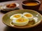 Hard-boiled and halved eggs placed on a plate.