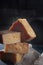 Hard cheeses on a dark background. Large chunks of cheese. Vertical photo. Long-aged cheese